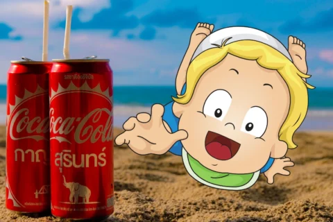 baby grabbing for a coke on beach