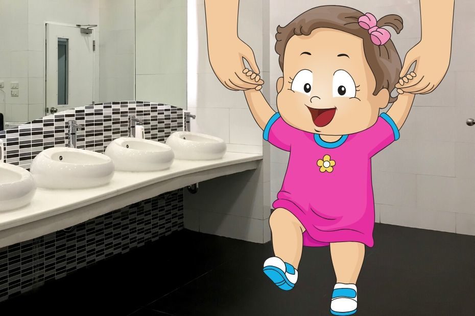 mother holding toddlers hand in public restroom