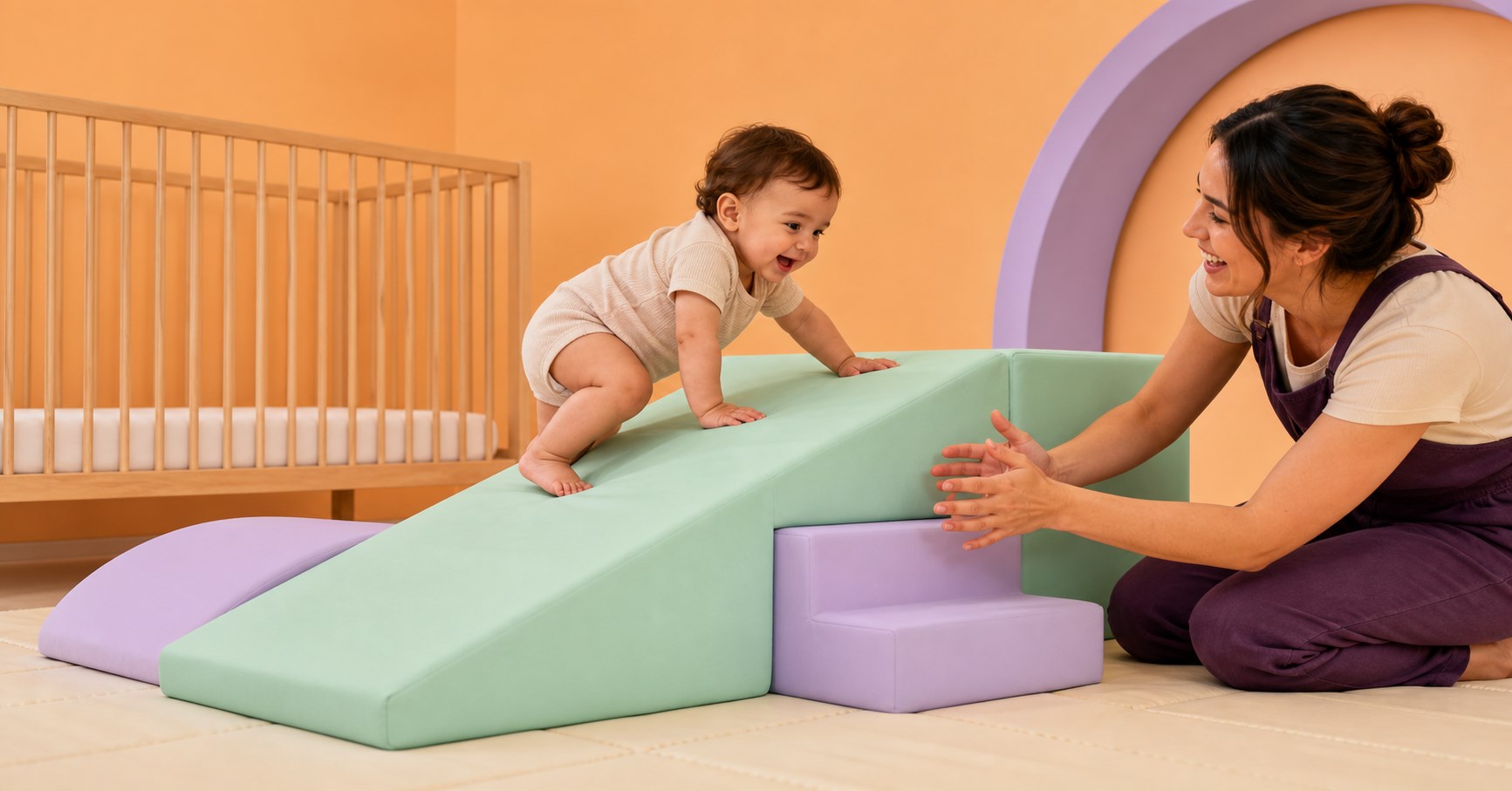 Baby climbing a low mint foam ramp while caregiver spots closely beside a bare crib