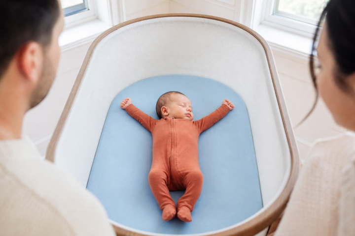 Editorial scene illustrating understanding why your baby stretches a lot while sleeping in a bright home setting.