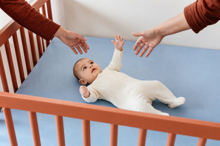 Editorial scene illustrating why your baby won't sleep in the crib and how to help in a bright home setting.
